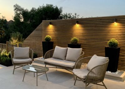 Outdoor timber panelling with uplighting for a garden renovation in Kent