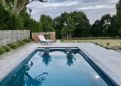 Contemporary outdoor pool and patio design in the Tunbridge Wells