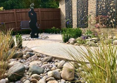 Stone pathway and pebble border in a garden renovation